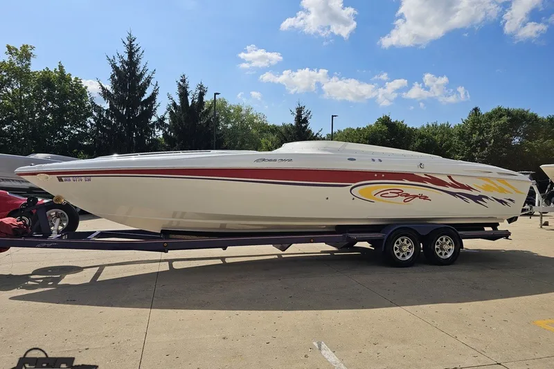 Slide: The Image of 2003 Baja 342 speedboat on trailer, vibrant graphics, parked outdoors under blue sky. - 15