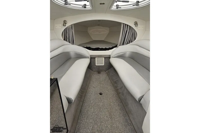 Slide: The Image of Interior of a 2003 Baja 342 boat with gray seating and carpeted flooring. - 59