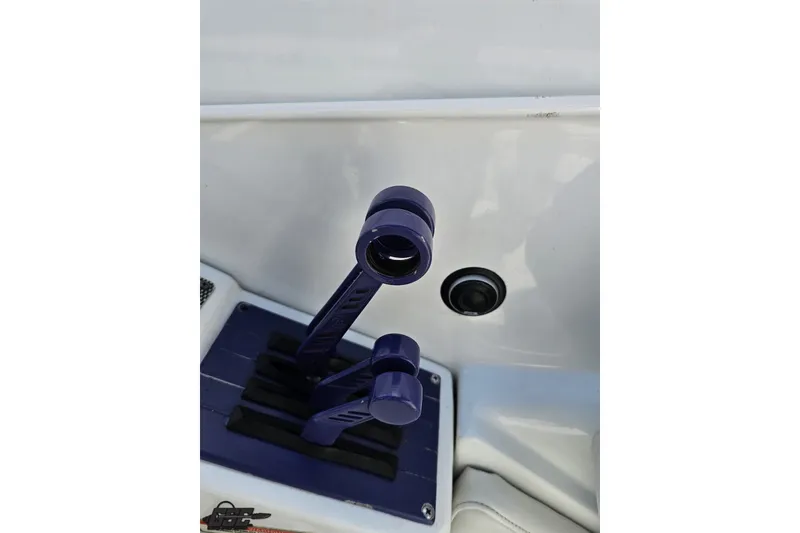 Slide: The Image of Throttle controls of a 2003 Baja 342 boat, featuring sleek purple handles. - 85