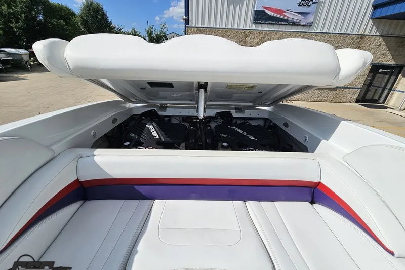 Slide: The Image of 2003 Baja 342 boat engine compartment with white seating and vibrant accents. - 81