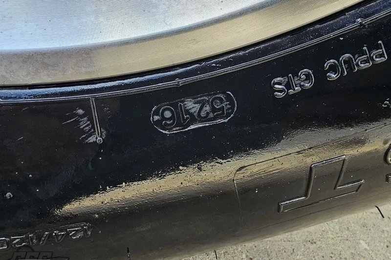 Slide: The Image of Close-up of a 2003 Baja 342 boat hull with embossed model details. - 90