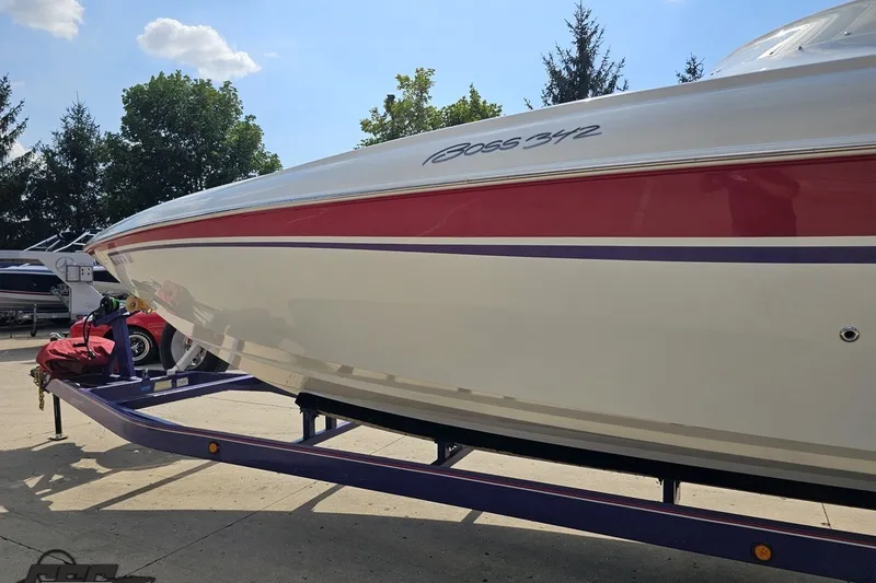 Slide: The Image of 2003 Baja 342 boat on trailer, featuring sleek red and white design. - 22
