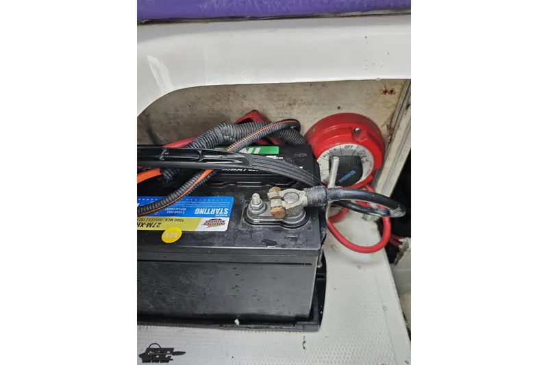 Slide: The Image of Battery and wiring inside a 2003 Baja 342 boat, featuring a red power switch. - 80