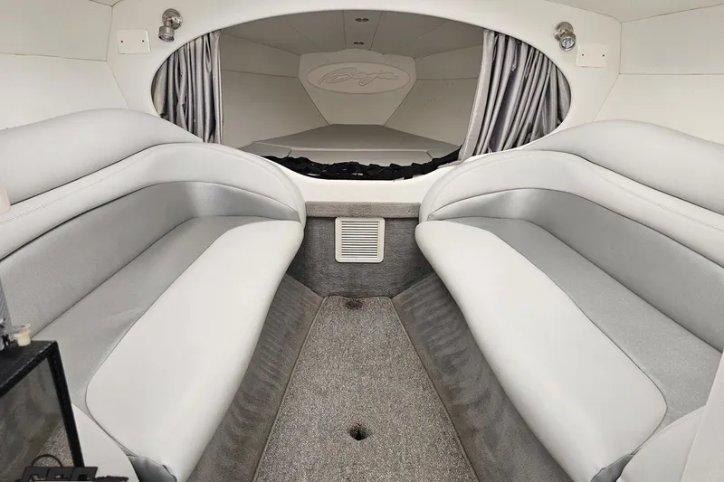 Slide: The Image of Interior of a 2003 Baja 342 boat with gray seating and carpet. - 61