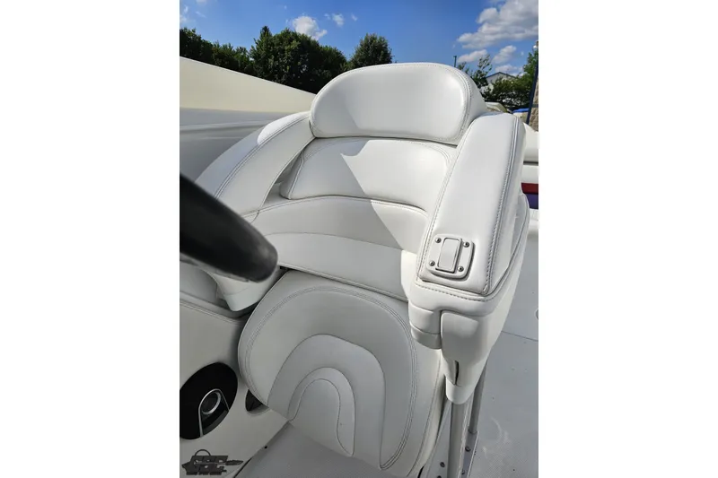 Slide: The Image of White leather seat on a 2003 Baja 342 boat, under a clear blue sky. - 73