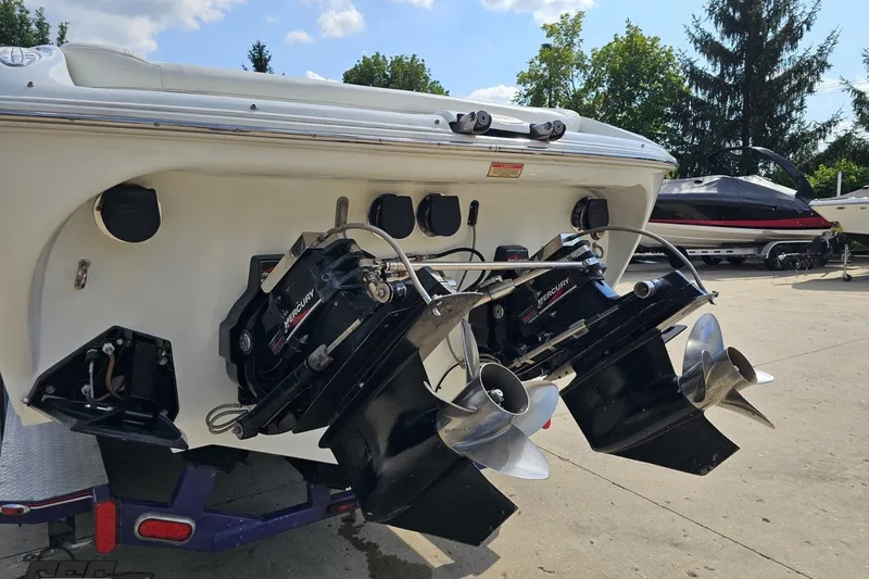 Slide: The Image of 2003 Baja 342 boat with dual Mercury outboard engines, parked outdoors. - 26