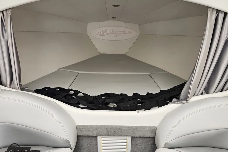 Slide: The Image of Interior cabin of a 2003 Baja 342 boat with cushioned seating and curtains. - 65