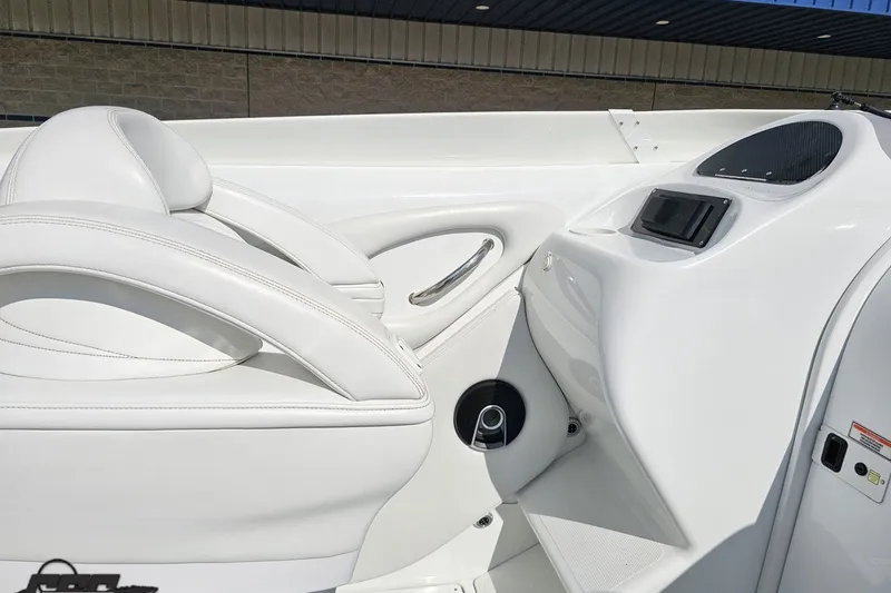 Slide: The Image of Interior of a 2003 Baja 342 boat featuring sleek white seating and modern dashboard. - 44