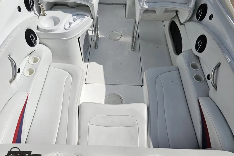 Slide: The Image of Interior of a 2003 Baja 342 boat with white seating and cup holders. - 37