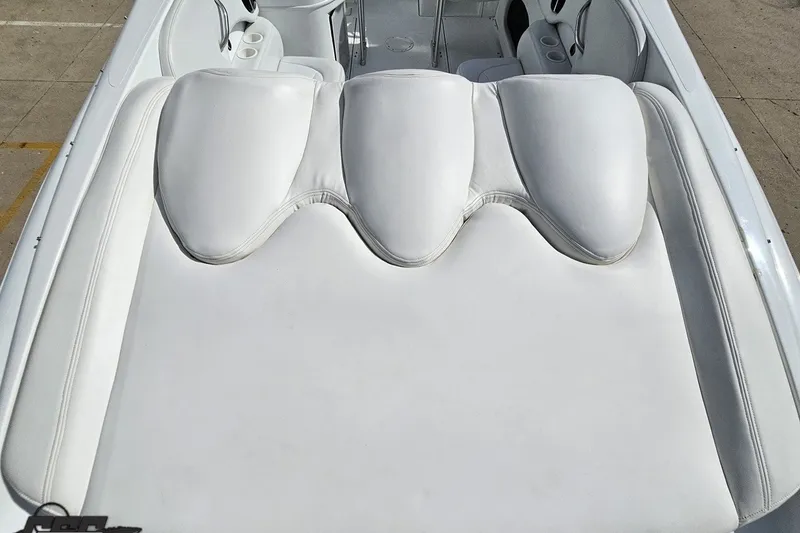 Slide: The Image of 2003 Baja 342 boat interior with white cushioned seating and sleek design. - 33