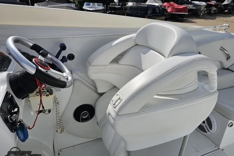 Slide: The Image of 2003 Baja 342 boat cockpit with white leather seats and steering wheel. - 46