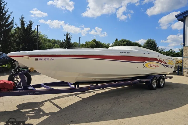 Slide: The Image of 2003 Baja 342 boat on trailer under blue sky, parked outdoors. - 14