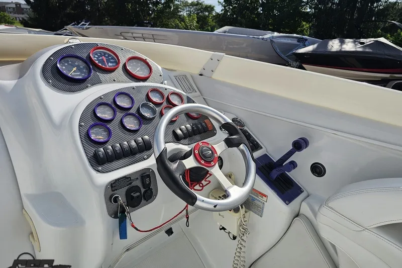 Slide: The Image of Cockpit of a 2003 Baja 342 boat with gauges and steering wheel. - 48