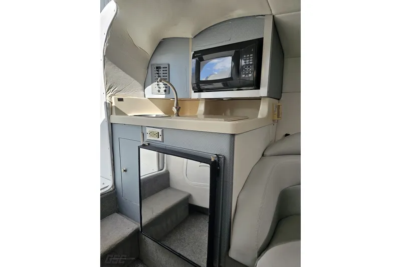 Slide: The Image of 2003 Baja 342 cabin interior with microwave, sink, and storage. - 67