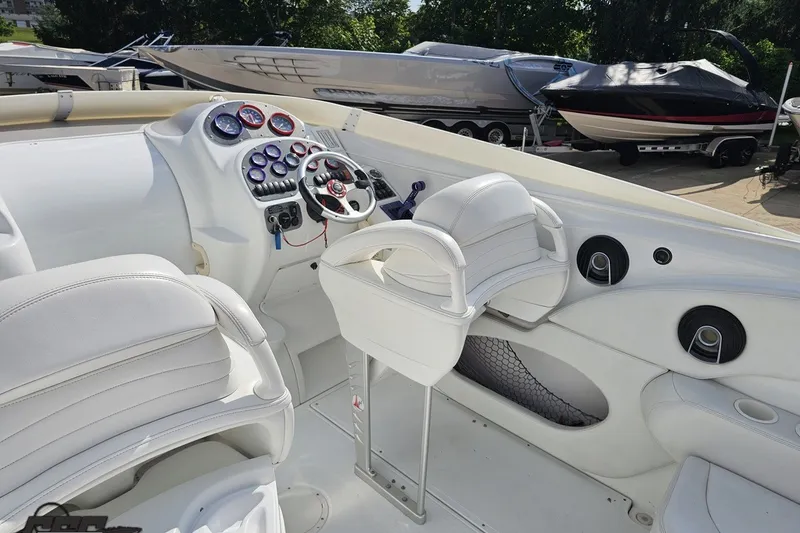 Slide: The Image of Interior of a 2003 Baja 342 boat with white seating and control panel. - 40