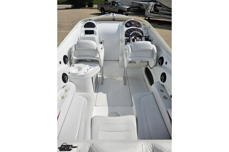 Slide: The Image of 2003 Baja 342 boat interior with white seating and modern dashboard controls. - 36