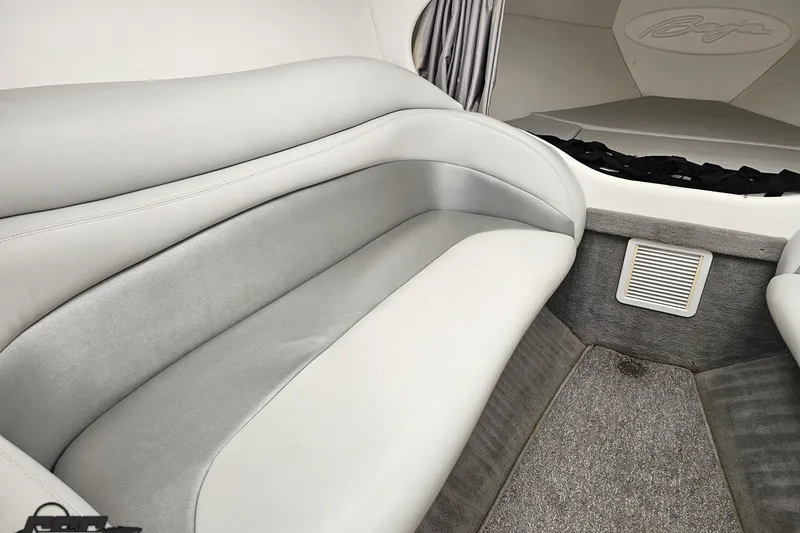 Slide: The Image of Interior of a 2003 Baja 342 boat with gray seating and carpeted flooring. - 66