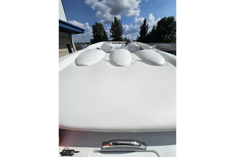 Slide: The Image of 2003 Baja 342 boat with sleek white deck under a clear blue sky. - 30