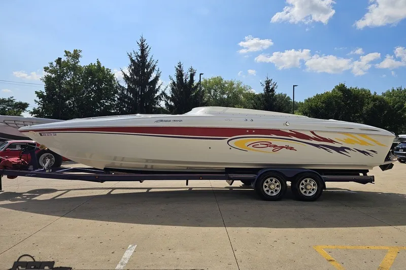 Slide: The Image of 2003 Baja 342 speedboat on trailer, featuring vibrant graphics, parked outdoors. - 16