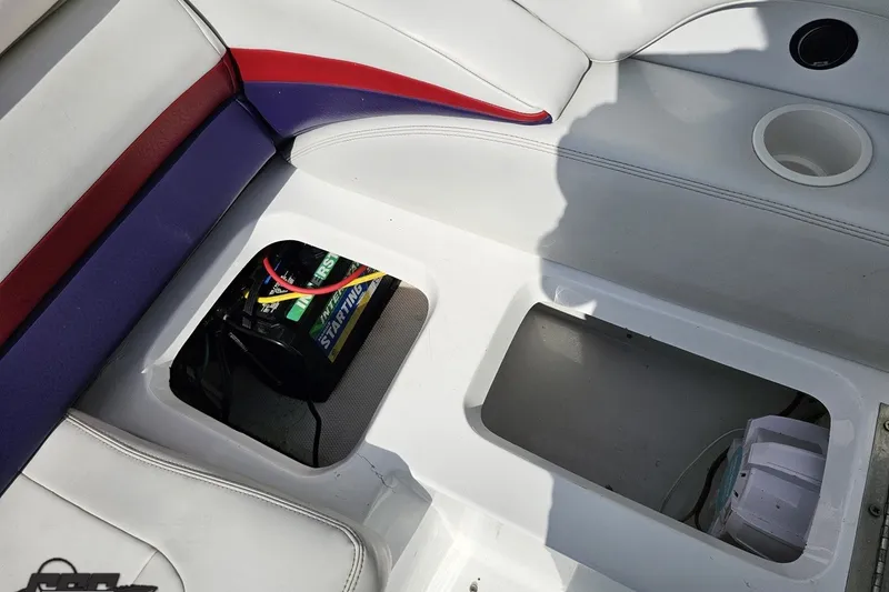 Slide: The Image of 2003 Baja 342 boat interior showing battery compartment and seating area. - 79