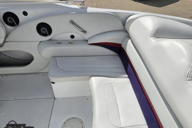 Slide: The Image of Interior seating of a 2003 Baja 342 boat with white upholstery and cup holders. - 38
