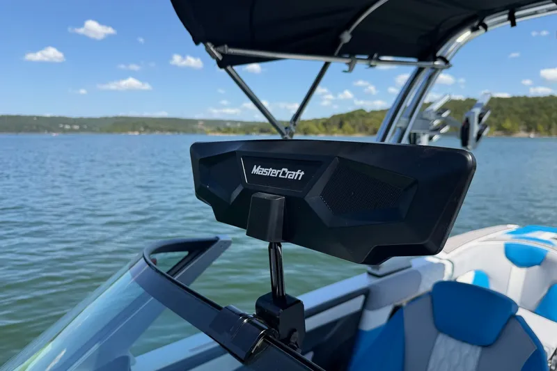 Slide: The Image of 2023 MasterCraft XT23 boat on a lake, featuring sleek design and modern equipment. - 24