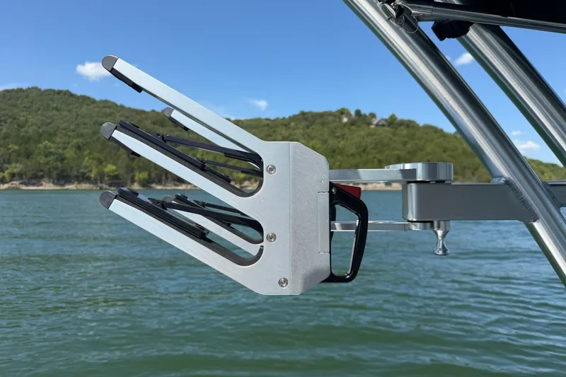 Slide: The Image of Wakeboard rack on 2023 MasterCraft XT23 boat, lake and hills in background. - 19