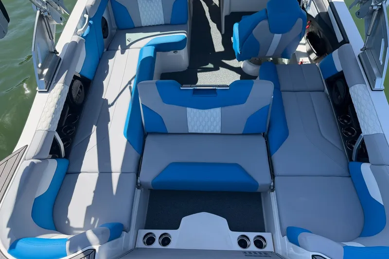 Slide: The Image of 2023 MasterCraft XT23 boat interior with blue and gray seating, showcasing spacious and stylish design. - 28