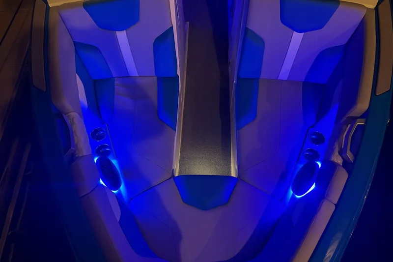 Slide: The Image of 2023 MasterCraft XT23 boat interior with blue LED lighting and stylish seating. - 44