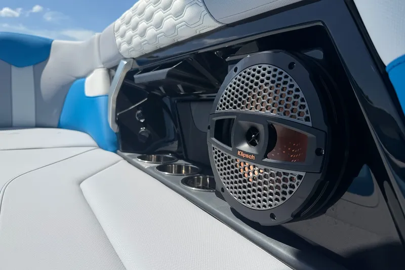 Slide: The Image of 2023 MasterCraft XT23 boat interior with Klipsch speaker and cup holders. - 18
