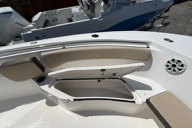 Slide: The Image of 2018 Tidewater 220 LXF boat interior with open storage compartments and seating. - 20