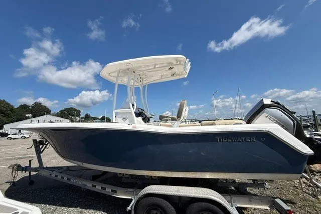 Slide: The Image of 2018 Tidewater 220 LXF boat on trailer under clear blue sky. - 7
