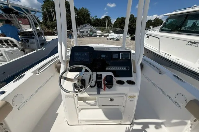 Slide: The Image of 2018 Tidewater 220 LXF boat dashboard with steering wheel and control panel. - 13
