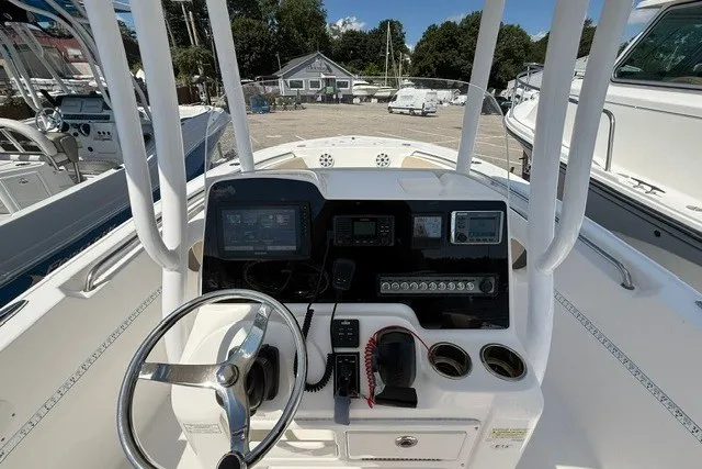 Slide: The Image of 2018 Tidewater 220 LXF boat dashboard with steering wheel and navigation controls. - 14