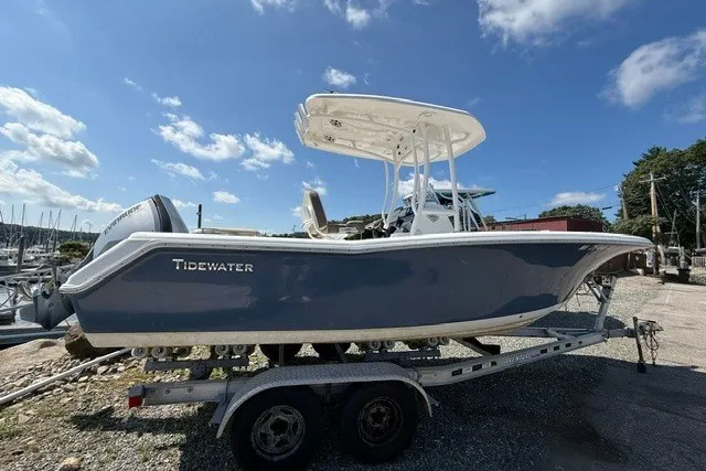 Slide: The Image of 2018 Tidewater 220 LXF boat on trailer under clear blue sky. - 4