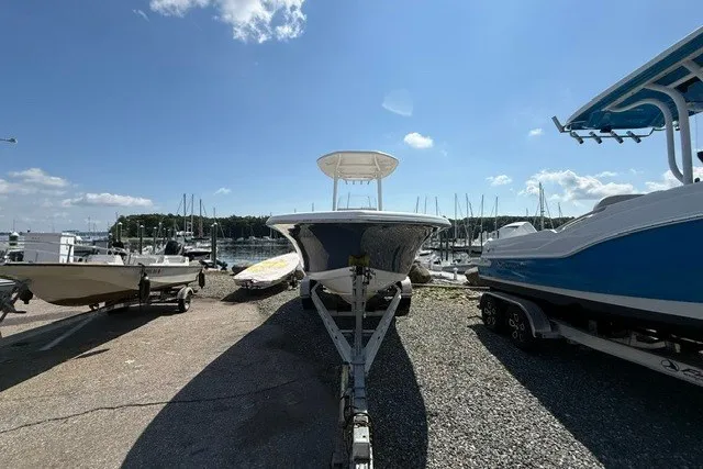 Slide: The Image of 2018 Tidewater 220 LXF boat on trailer at marina under clear blue sky. - 3