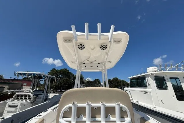 Slide: The Image of 2018 Tidewater 220 LXF boat with T-top and rod holders under clear blue sky. - 10
