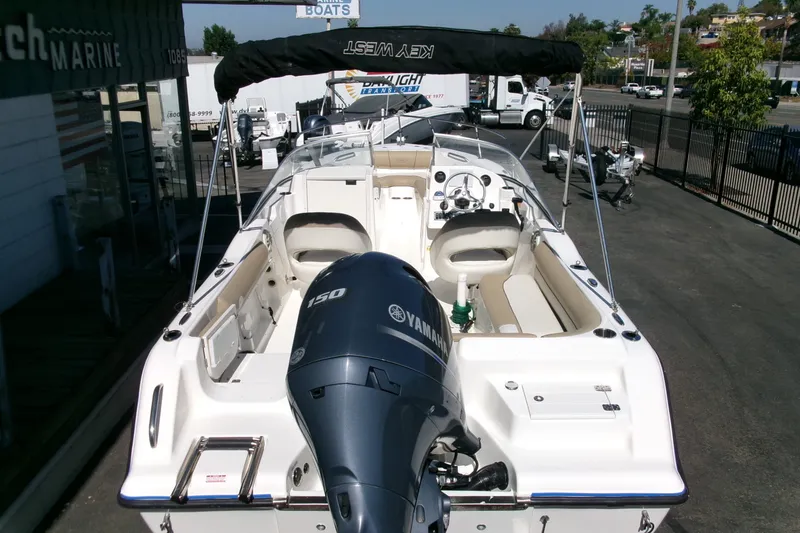 Slide: The Image of 2020 Key West 203 DFS boat with Yamaha 150 engine, parked at a marina. - 24