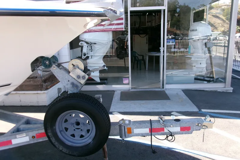 Slide: The Image of Boat trailer with Key West 203 DFS, 2020 model, parked outside a showroom with Yamaha engines. - 22