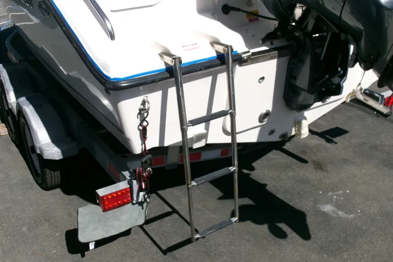 Slide: The Image of Rear view of a 2020 Key West 203 DFS boat on a trailer with ladder. - 20