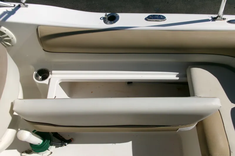 Slide: The Image of 2020 Key West 203 DFS boat interior with beige seating and cup holder. - 17