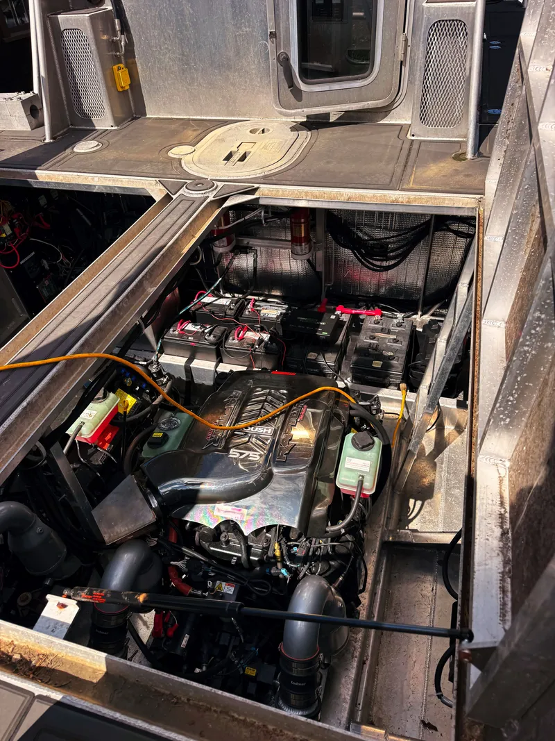 Slide: The Image of The engine compartment of a Norsco Aluminum Patrol 32 boat shows a modern engine and batteries. - 9