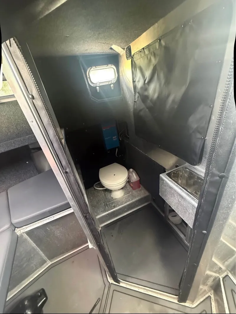 Slide: The Image of Interior of an aluminum patrol boat with a toilet and sink. - 5