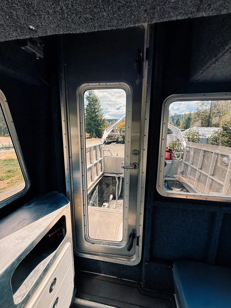 Slide: The Image of Interior view of a 2023 Norsco Aluminum Patrol 32 with sturdy design and large windows. - 26