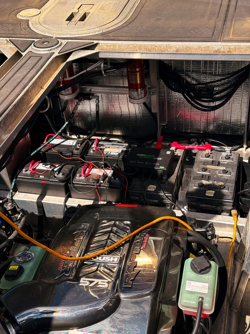Slide: The Image of Engine compartment of a Norsco Aluminum Patrol 32 with batteries and wiring. - 10