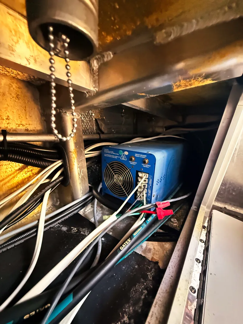 Slide: The Image of A technical area with cables and a blue device inside a boat. - 13