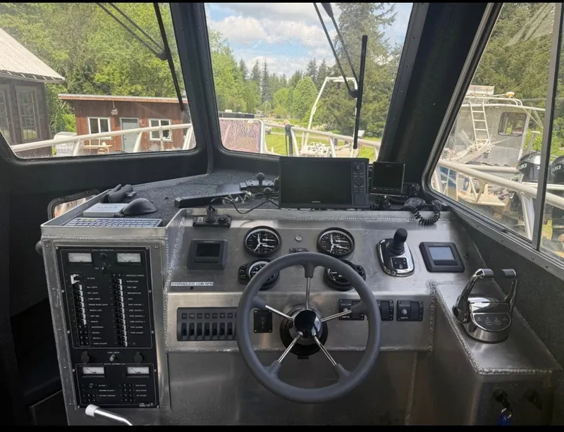 Slide: The Image of The cockpit of a Norsco Aluminum Patrol 32 boat with modern instruments and controls. - 6