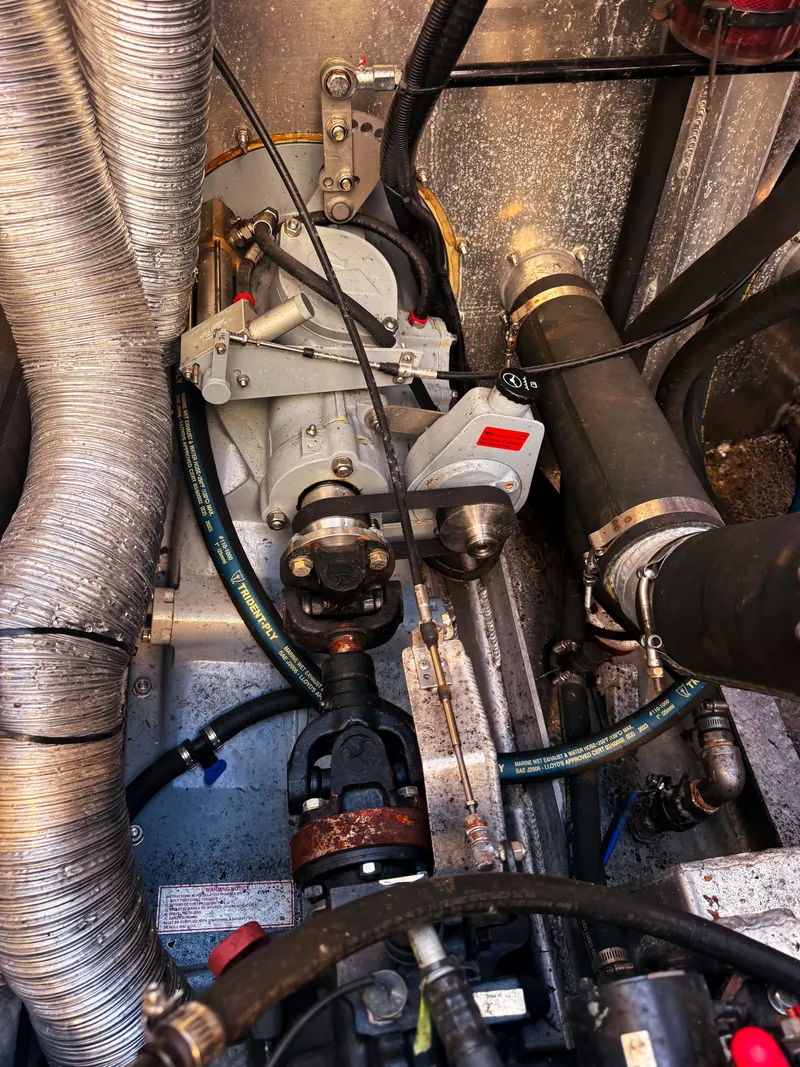 Slide: The Image of Engine compartment of a Norsco Aluminum Patrol 32 boat with hoses and mechanical components. - 15
