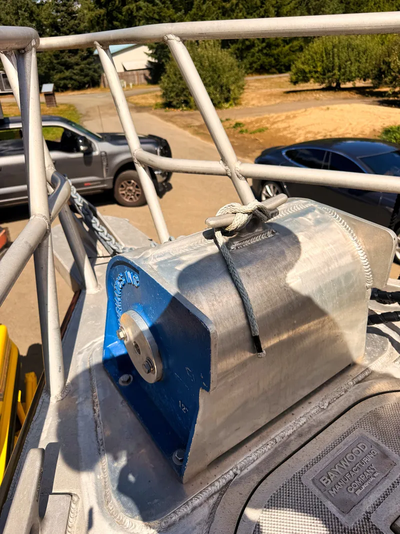 Slide: The Image of An aluminum boat with a blue winch mechanism and sturdy railing. - 22
