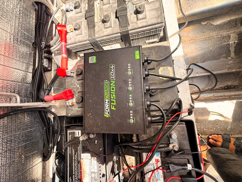 Slide: The Image of Batteries and charger in a boat engine compartment. - 18